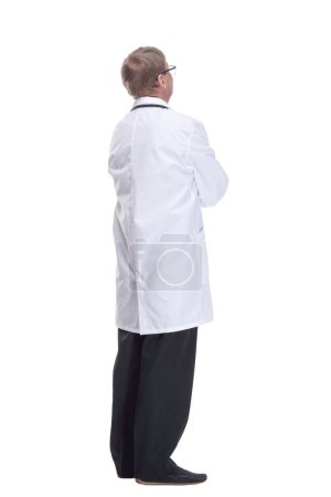 Photo for In full growth.Mature doctor with a stethoscope reading an ad on a white screen. isolated on a white background. - Royalty Free Image