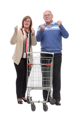 Photo for In full growth. casual elderly couple with shopping cart. isolated on a white - Royalty Free Image