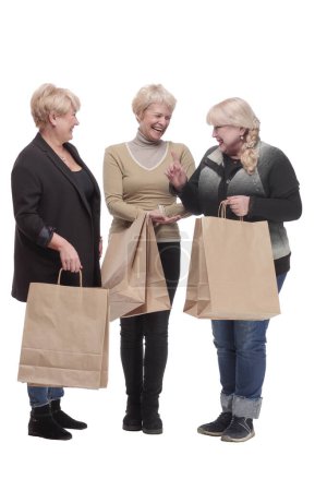 Photo for In full growth. three happy women with shopping bags. isolated on a white background. - Royalty Free Image
