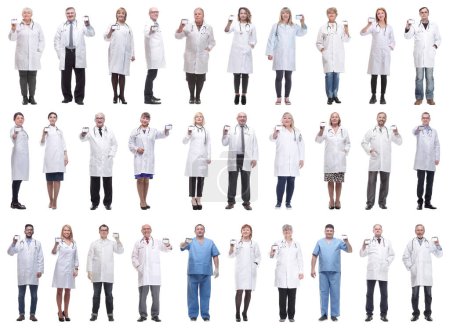 Photo for Full length group of doctors showing badge isolated on white background - Royalty Free Image