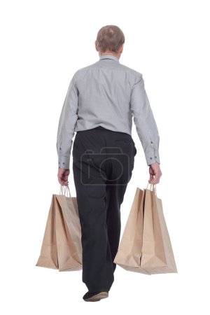 Photo for Rear view. casual man with shopping bags strides away. isolated on a white background. - Royalty Free Image