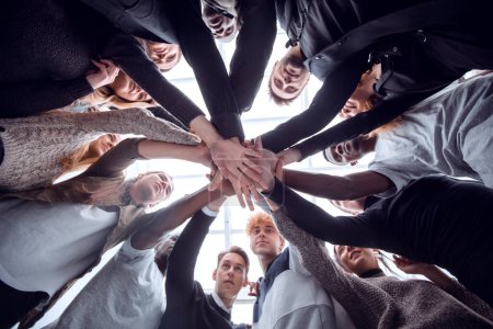 Photo for Bottom view. group of happy young people making a tower out of their hands . concept of unity - Royalty Free Image
