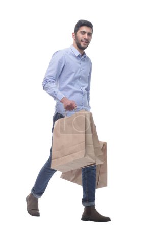 Photo for In full growth. happy man with shopping bags confidently striding forward. isolated on a white background. - Royalty Free Image