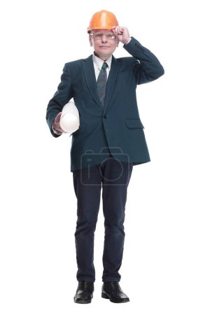 Photo for In full growth. confident architect with sketches adjusting his protective helmet . isolated on a white background. - Royalty Free Image