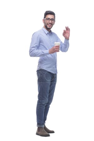 Photo for Young smiling man holding a takeaway coffee. isolated on a white background. - Royalty Free Image