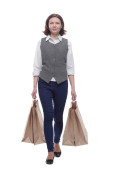 casual mature woman with shopping bags striding forward . isolated on a white background. magic mug #649684272