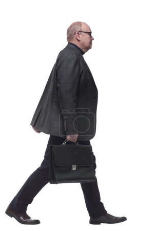 Photo for Side view. a business man with a leather briefcase striding forward. isolated on a white background - Royalty Free Image