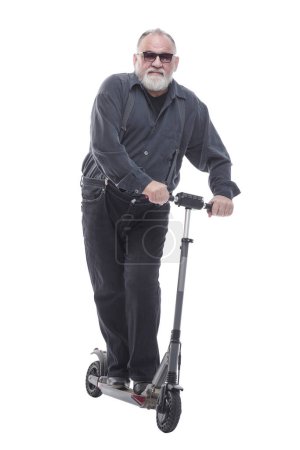 Photo for In full growth. elderly man standing on electric scooter. isolated on a white background - Royalty Free Image