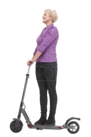 Photo for In full growth. smiling mature woman with an electric scooter . isolated on a white background. - Royalty Free Image