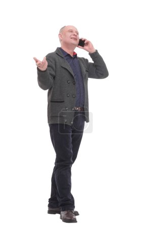Photo for In full growth. smiling mature man with a smartphone .isolated on a white background. - Royalty Free Image