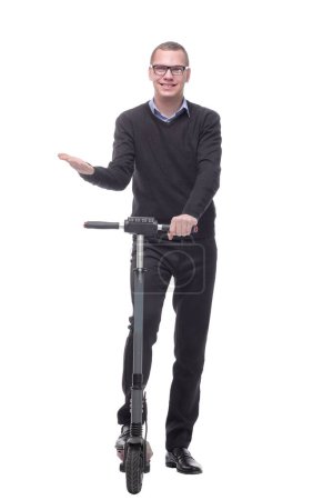 Photo for Full length portrait of an young man riding a scooter isolated on white background - Royalty Free Image