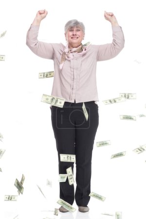 Photo for In full growth. very happy old woman standing in a rain of dollar bills . isolated on a white background. - Royalty Free Image