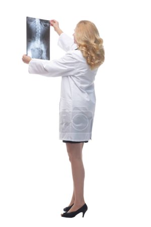 Photo for Side view. female doctor looking at an x-ray. isolated on a white background. - Royalty Free Image