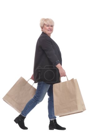 Photo for Full-length. casual mature woman with shopping bags . isolated on a white background. - Royalty Free Image