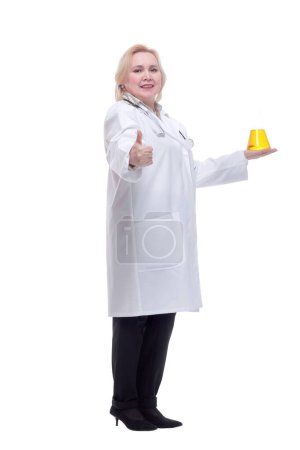 Beautiful women doctor medical suit holding beaker with yellow liquid