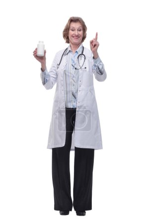 Téléchargez les photos : Femme médecin en blouse médicale index de point vers le haut et tenir boîte de pilule quotidienne. Personnel de santé médecine concept de santé - en image libre de droit