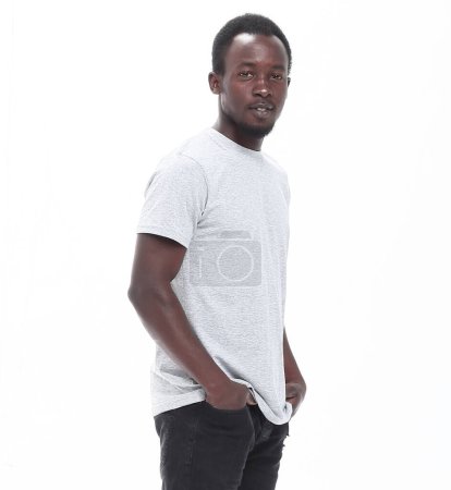Foto de En pleno crecimiento. Un tipo guapo en jeans y una camiseta. aislado en blanco - Imagen libre de derechos