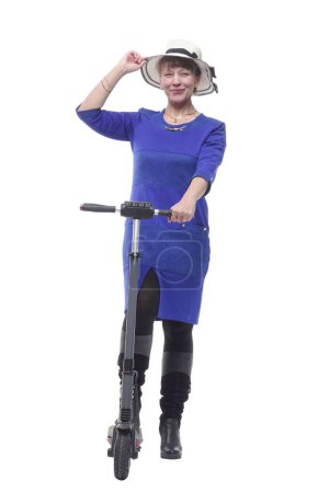 Photo for Front view of young woman in dress and hat on kick scooter isolated on white background - Royalty Free Image