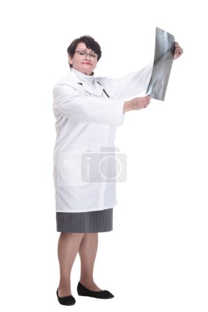 Photo for In full growth. older woman is a medic with an x-ray in her hands. isolated on a white background. - Royalty Free Image