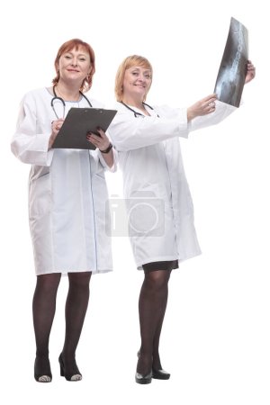 Photo for In full growth. two female doctors with x-rays. isolated on a white background. - Royalty Free Image