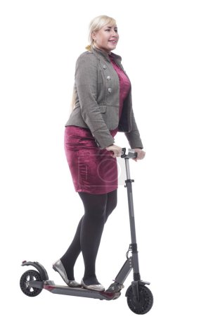 Foto de En pleno crecimiento. atractiva mujer feliz con un scooter eléctrico. aislado sobre un fondo blanco. - Imagen libre de derechos
