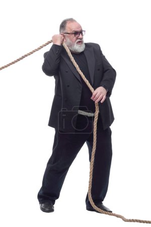 Photo for Side view. Mature businessman in glasses pulls the rope . isolated on a white background. - Royalty Free Image