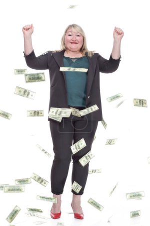 in full growth. attractive plump woman standing in the rain of banknotes. isolated on a white background.