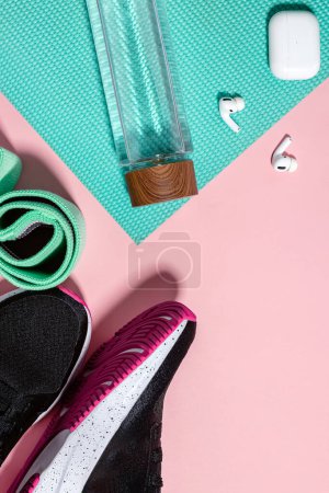 Photo for Gym or workout at home accessories on pink background, top view. - Royalty Free Image
