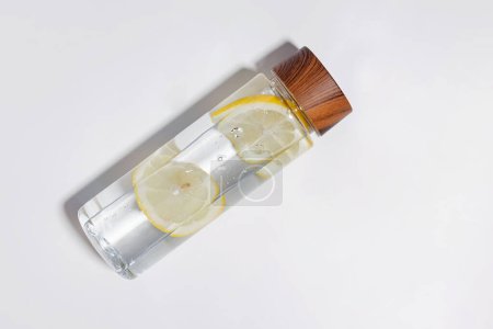 Photo for Stylish reusable bottle with lemon infused water isolated on white background - Royalty Free Image