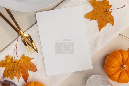 Photo for Thanksgiving invitation mock-up, fall table setting with leaves and blank paper card, place for text - Royalty Free Image