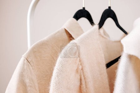 Photo for Close-up of Beige female clothing on the hangers - Royalty Free Image