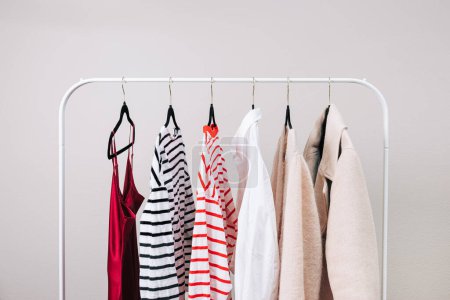 Photo for Wardrobe essentials, stylish woman's closing on the rack - Royalty Free Image