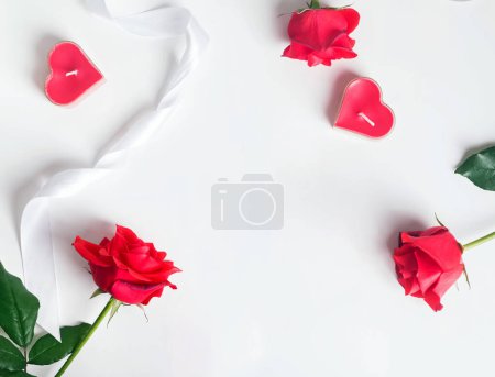 Photo for Valentine's day flat lay composition with red roses and heart shaped candles on white background - Royalty Free Image