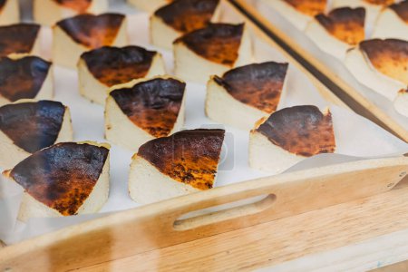 Slices of traditional burnt basque cheese cakes at the window display at local bakery, Bilbao, Spain