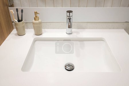 Photo for Chrome faucet and white granite sink in the bathroom - Royalty Free Image