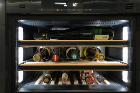 Photo for Kyiv, Ukraine - 26 october, 2018: Bottles of wine in a home wine fridge - Royalty Free Image