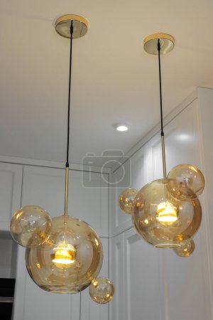 Photo for Modern glowing hanging lamps from the ceiling - Royalty Free Image