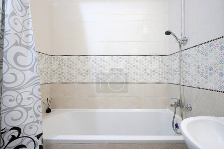 Photo for Chrome chower over the bath in the interior of the bathroom - Royalty Free Image