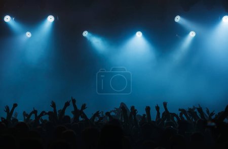 Photo for Background with concert crowd hands. Wallpaper with empty stage on music festival. Illuminated scene on popular musical event - Royalty Free Image