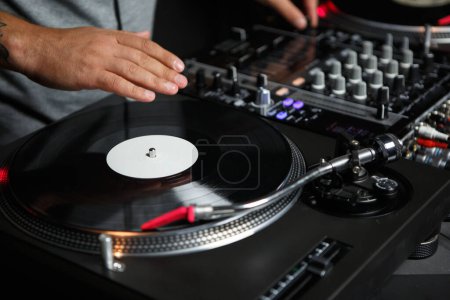Photo for Hip hop dj plays music set on concert. Professional disc jockey turntable with vinyl record - Royalty Free Image