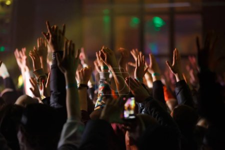 Photo for Concert crowd put hands up on dance floor. Group of happy young people enjoying music festival - Royalty Free Image