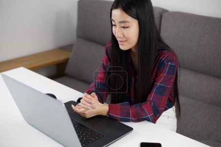 Photo for BIPOC Vietnamese girl studying online with notebook computer. Cheerful young asian female communicating on video call - Royalty Free Image