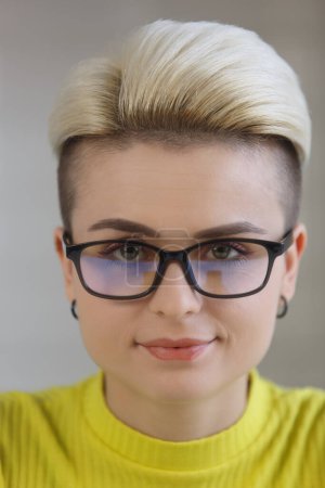 Photo for Portrait of young woman with stylish hairstyle. Beautiful white female person with short dyed hair looking in camera with a smile - Royalty Free Image
