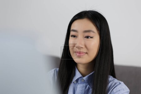 Photo for Young POC woman from Vietnam working on laptop at home. Portrait of beautiful Asian girl using modern notebook pc for work - Royalty Free Image