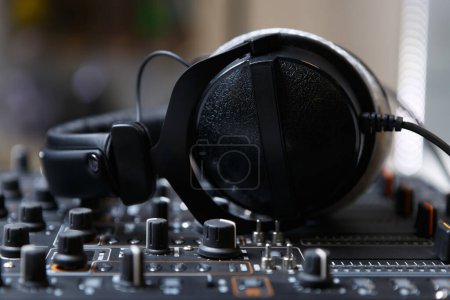 Photo for DJ headphones on sound mixer. Close up photo of professional headset for disc jockey - Royalty Free Image