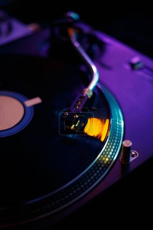 Photo for Dj turntable playing music on stage. Overhead photo of professional disc jockey player with vinyl record - Royalty Free Image