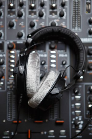 Foto de DJ headphones on sound mixer. Professional disc jockey audio equipment shot directly from above on concert stage. - Imagen libre de derechos