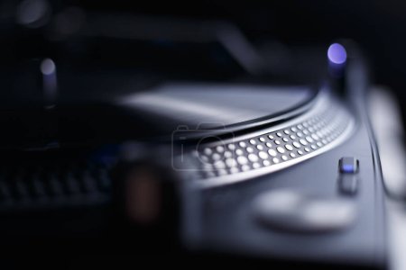Photo for Retro DJ turntable deck and black vinyl record. Listen to music in hi fi quality - Royalty Free Image