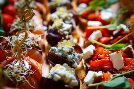 Photo for Gourmet snack food catering. Exotic canapes with caviar, blue cheese, jamon meat and feta delivered on venue - Royalty Free Image