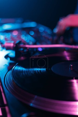 Photo for DJ turntable playing vinyl record with music on hip hop party in night club - Royalty Free Image